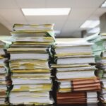 stacks of paper documents and file folders